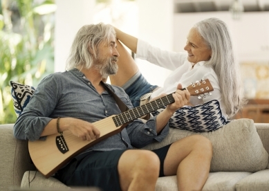 Mature Couple Playing Music on Couch